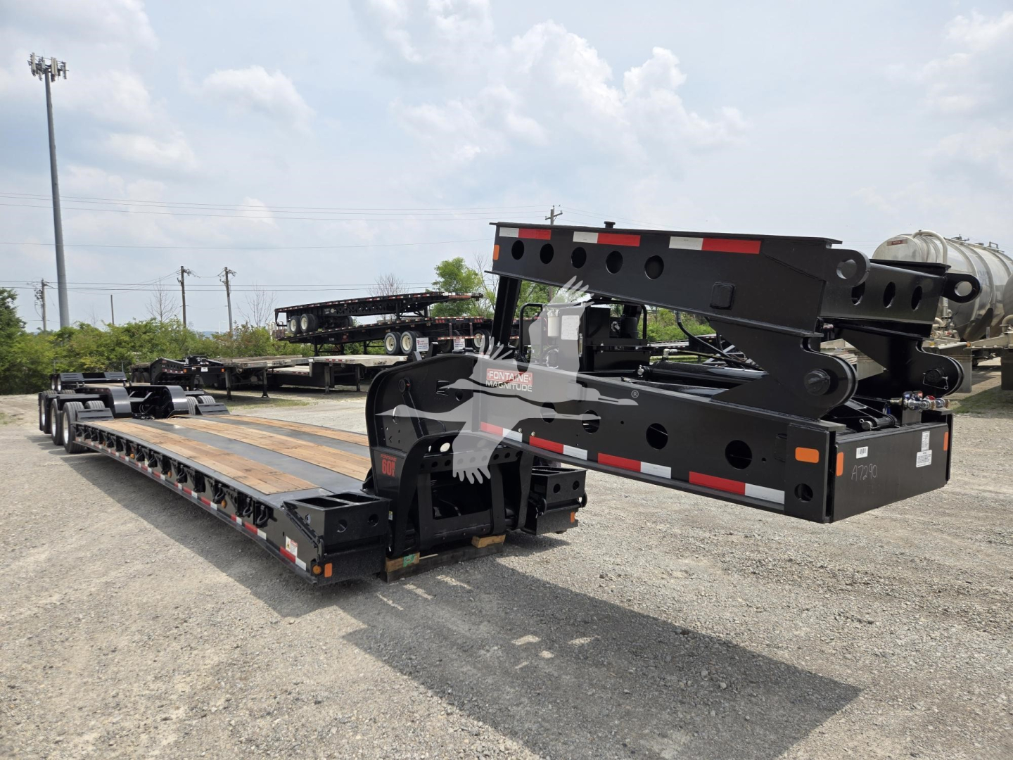 Fontaine 60HD MX lowboy trailer in new condition, extended flatbed with hydraulic gooseneck and heavy-duty frame visible in a lot.