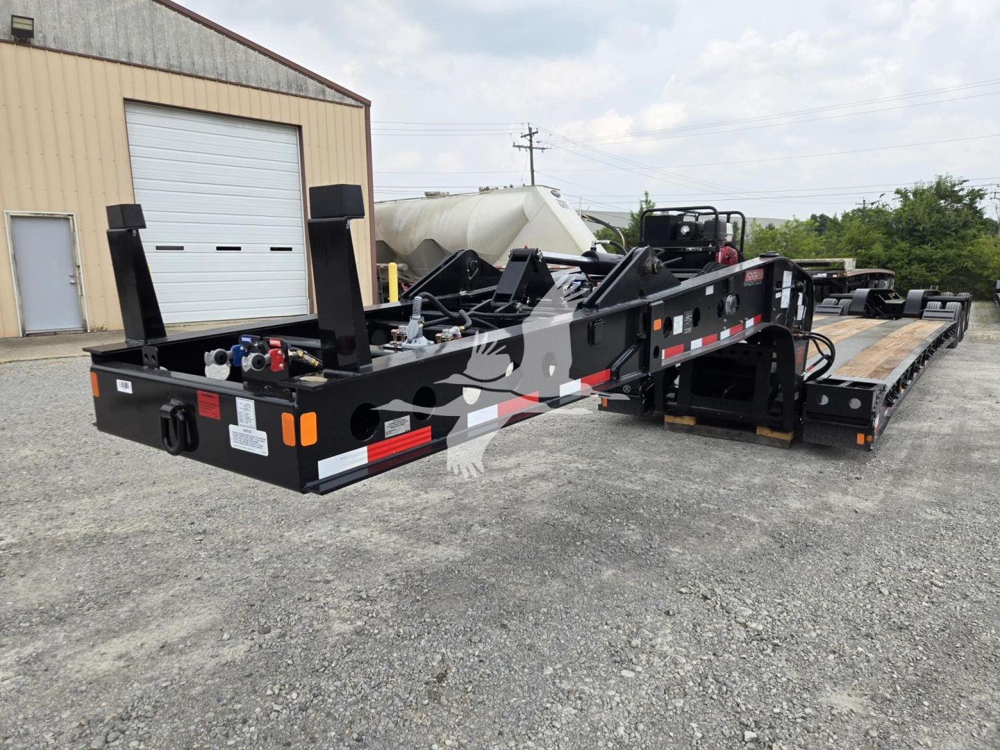 New Fontaine 60HD MX lowboy trailer shown from rear-left side with gooseneck and multiple axles, side ramps, and storage boxes.