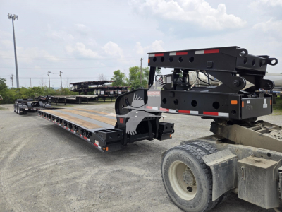  Fontaine 60HD MX lowboy trailer in new condition showing extended deck and kingpin area with hydraulic gooseneck and hinge components.