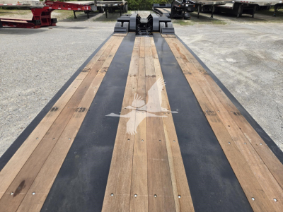 Trailer deck showing wooden planks with black center strip on Fontaine 60HD MX lowboy trailer, front connection hardware visible.