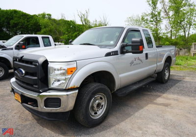 Ford F-250 XL SD extended cab white pickup truck viewed from the front driver's side showing chrome bumper, black grille, and extended cab with side step.