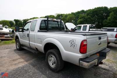 Ford F-250 XL SD extended cab pickup truck WT-4 in a used lot showing rear and side view with 4x4 badge.