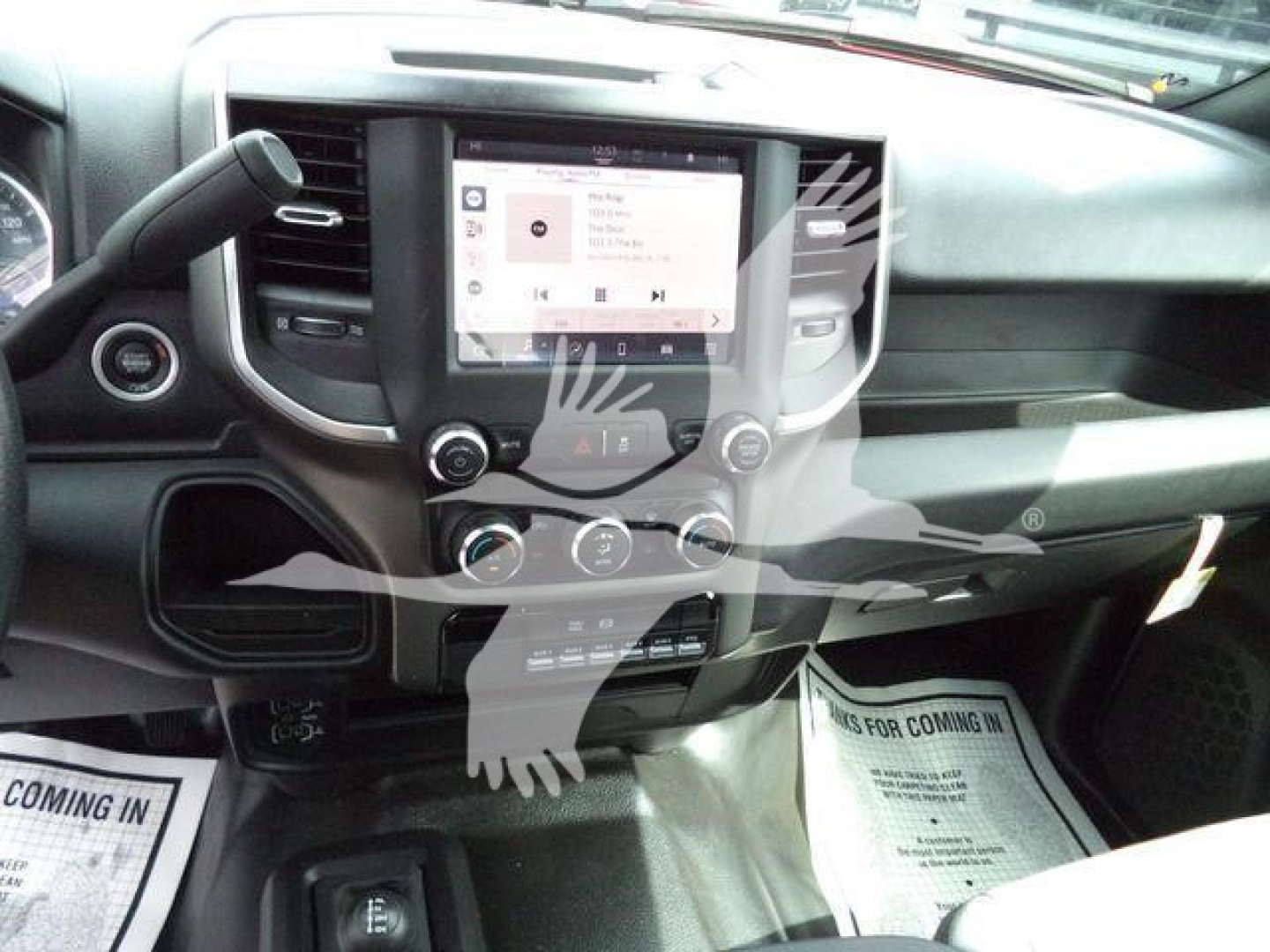 Ram 5500 dashboard view showing center touchscreen infotainment system and climate controls in a new pickup truck interior.