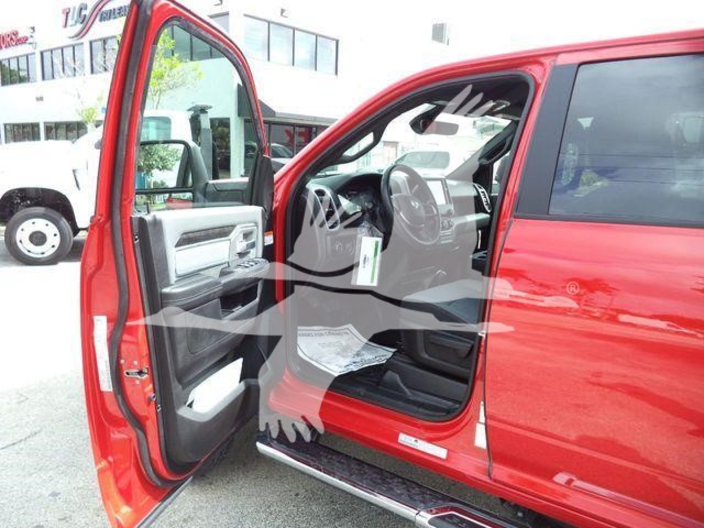 Ram 5500 truck interior view with front left door open showing steering wheel and dashboard.