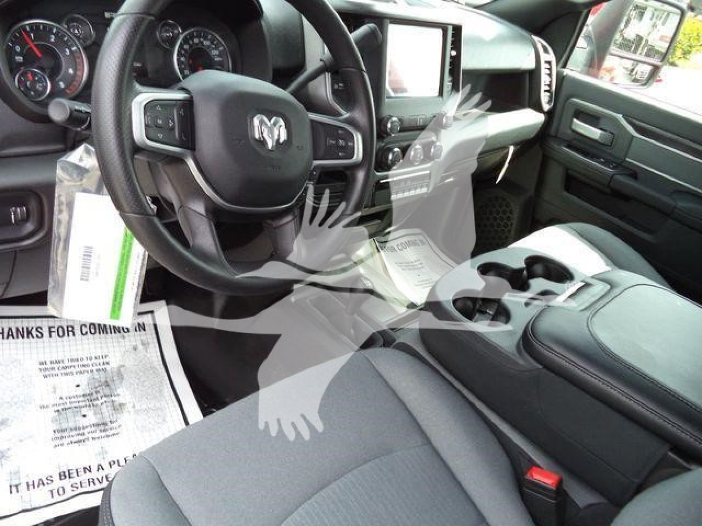 Ram 5500 interior showing steering wheel, center console, and driver seat with dashboard and touchscreen display.