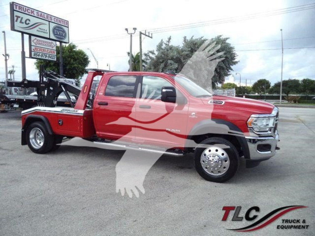 Red Ram 5500 SLT pickup with winch equipment on a dealership lot. Visible text includes TLC Truck Sales sign, MPL40RAM5500RED stock number, and WINCH center label.