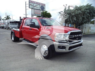 Ram 5500 pickup truck showing red exterior, chrome front bumper, black grille, dual rear wheels, winch category banner in background