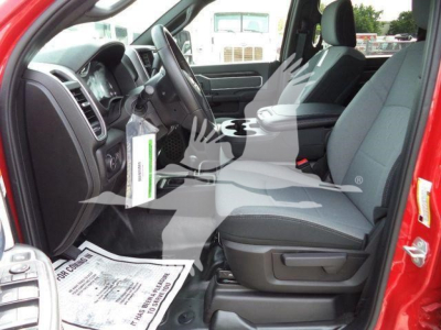 Ram 5500 interior view showing front seats and dashboard; blue-grey cloth seats and black center console with steering wheel visible.