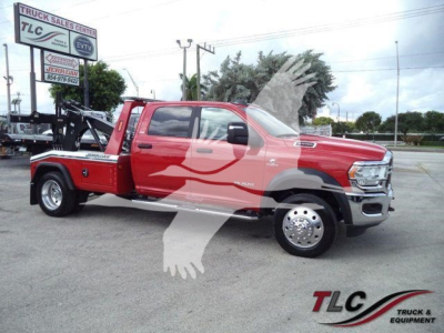 Red Ram 5500 SLT pickup with winch equipment on a dealership lot. Visible text includes TLC Truck Sales sign, MPL40RAM5500RED stock number, and WINCH center label.