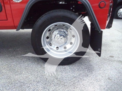 Hub and wheel area of a red Ram 5500 truck showing a polished steel wheel with center cap and black tire, wheel well and fender flare visible.