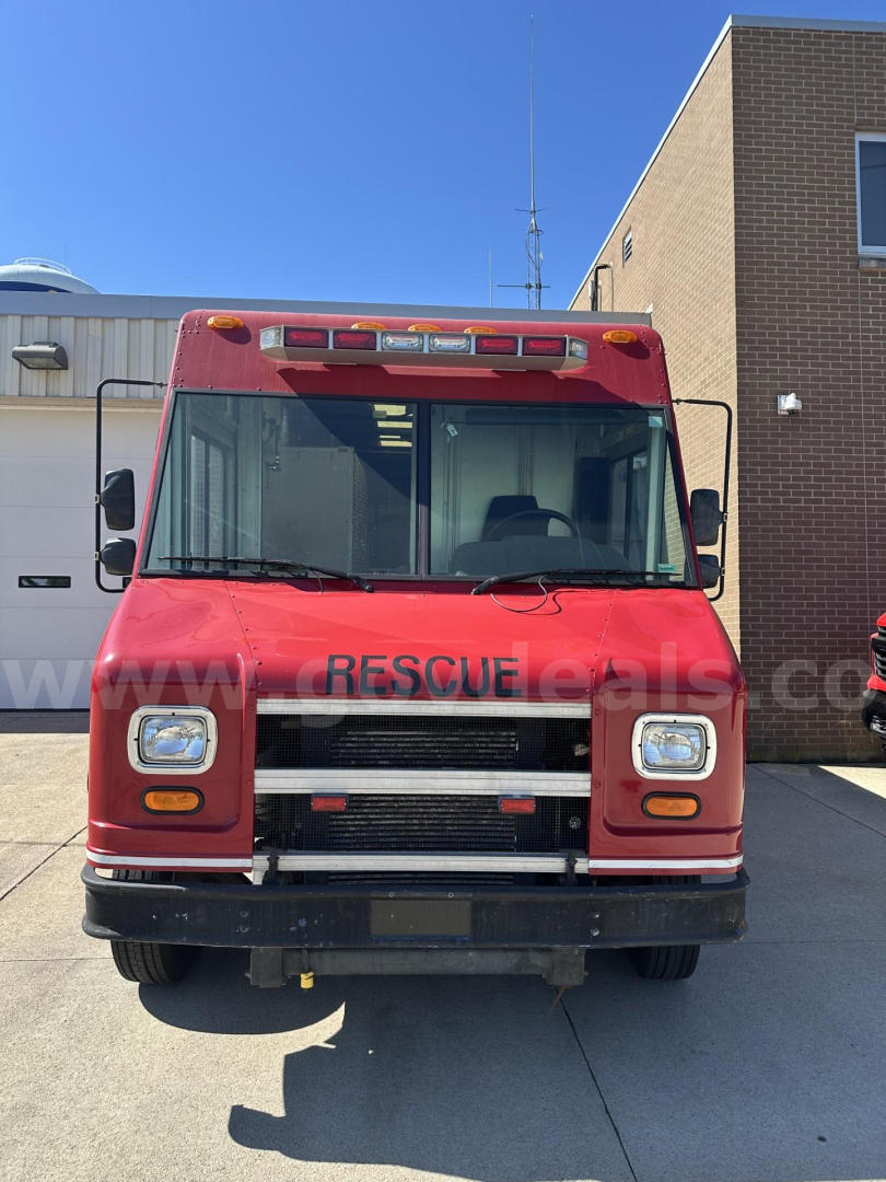 Front view of a red Freightliner MT45 cab and chassis rescue truck showing windshield, grille, bumper, and headlights.