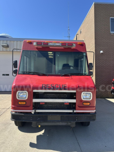 Front view of a red Freightliner MT45 cab and chassis rescue truck showing windshield, grille, bumper, and headlights.