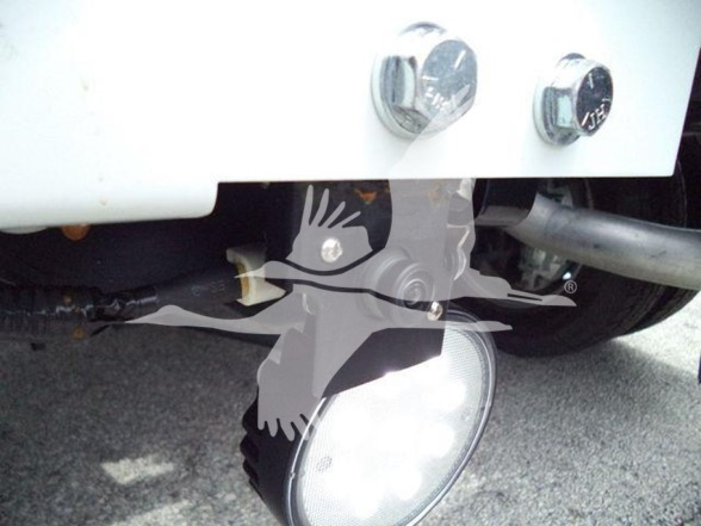 Truck front bumper area showing winch category; partial front wiring and fog light housing visible.
