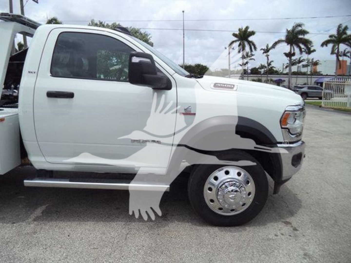 Ram truck side view showing model badges and cab, with overlay watermark of an eagle. Visible text includes 'RAM' badge on front fender and 'RAM 3500' style badge, but no clear VIN or stock text readable inside image.