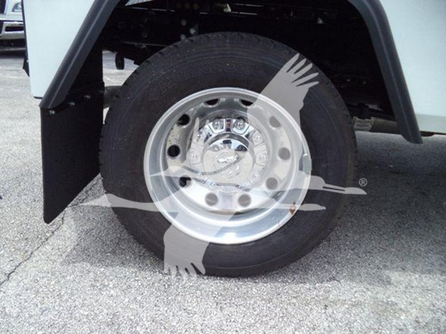 Ram truck wheel and fender showing wheel with chrome hubcap and tire; watermark of a logo overlaps image