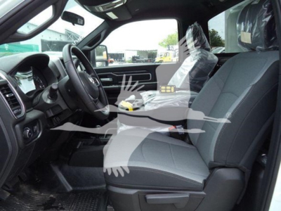Interior view of a 2024 Ram SLT pickup truck showing front seats and dashboard with a visible center console.