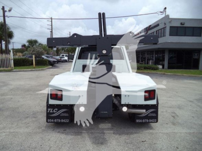 Truck rear view with winch attachment and hydraulic arms, RAM Slt listing.