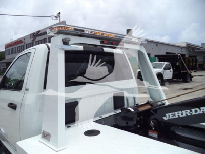 Truck cab rear showing winch mount and Jerr-Dan bodywork with overhead light bar and tow equipment visible.