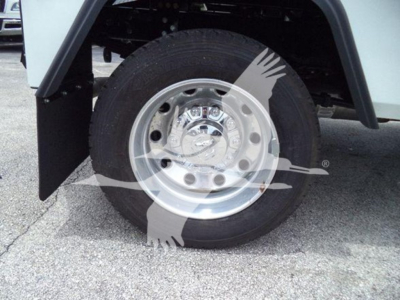 Ram truck wheel and fender showing wheel with chrome hubcap and tire; watermark of a logo overlaps image