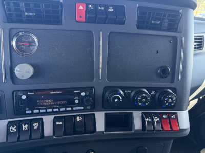 Kenworth T680 truck cab dashboard with gauges and radio display visible