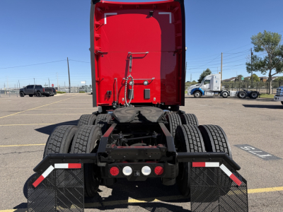Kenworth T680 rear view showing fifth wheel and dual rear axles in a parking lot.