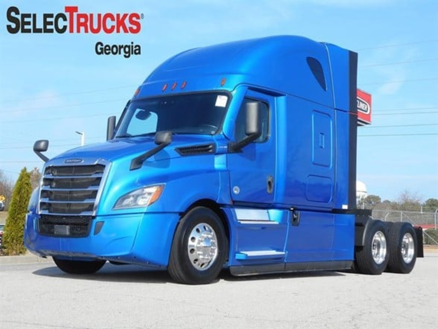 Truck image showing a blue 2022 Freightliner Cascadia 126 conventional sleeper cab with SelectTrucks Georgia logo in the corner.