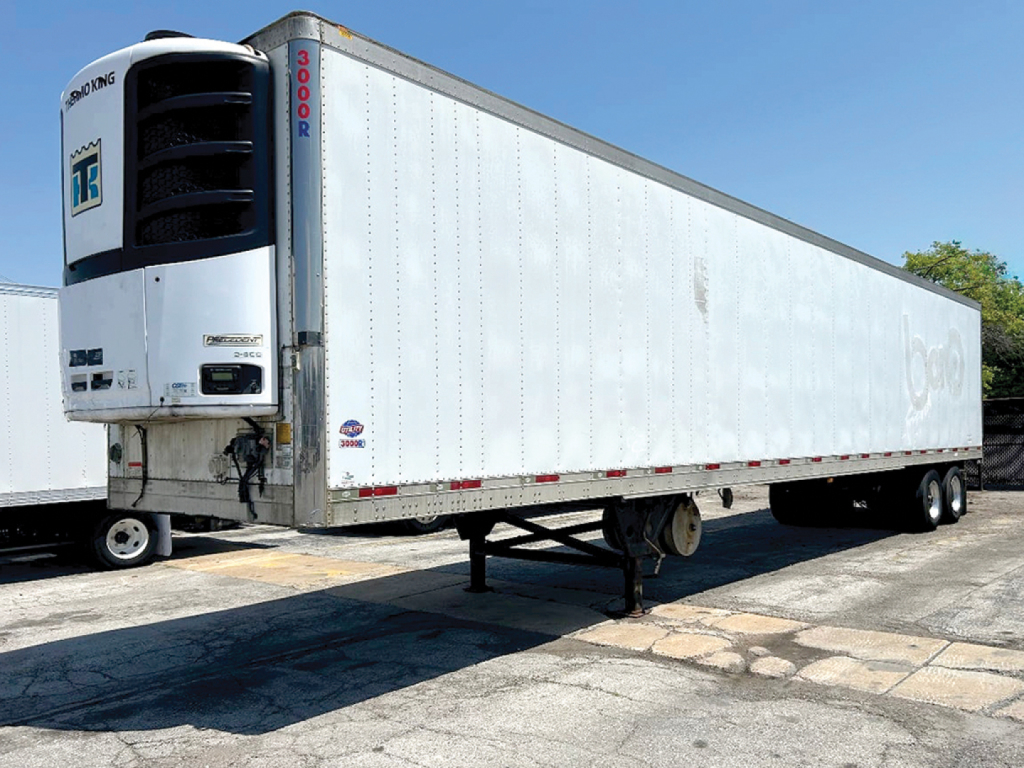 Utility 3000R trailer with refrigerated unit at front, white body, side view showing blue stripes and prep-free logo; front refrigeration unit with brand markings.