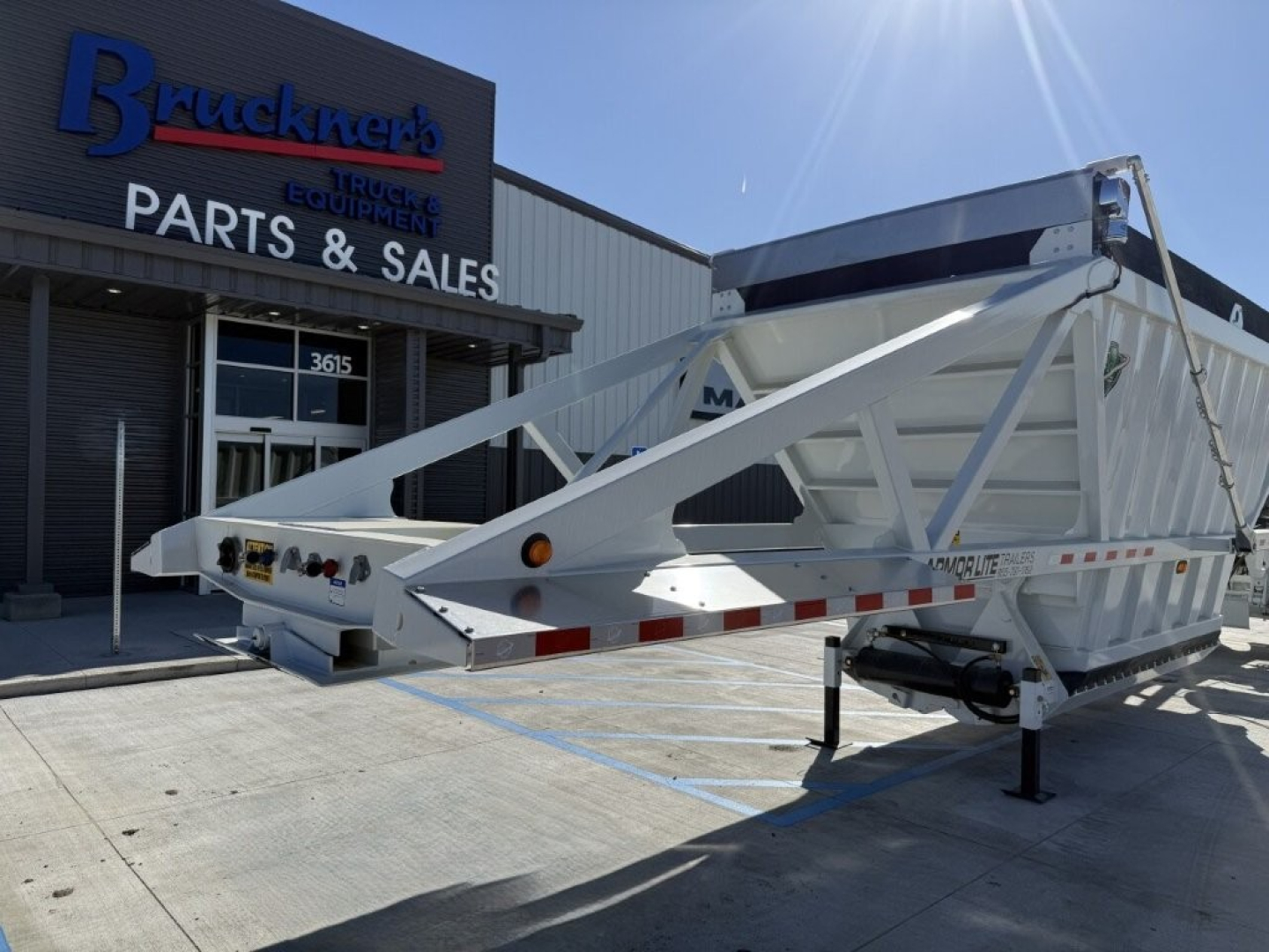 Trailer dump trailer showing Armor Lite SBD40 skeleton trailer with frame and support legs at Bruckner's Parts & Sales.