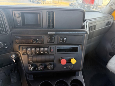 Dashboard of a 2019 International LT625 daycab showing gauges, controls, and a red and yellow pushbutton knobs.