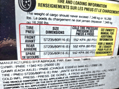 Trailer axle and tire information sticker showing tire sizes ST235/80R16 and cold tire pressure 552 KPA (80 PSI) with GVWR and GAWR details partially visible.