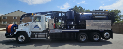 Truck-mounted vacuum unit on a 2020 Western Star 4700 with reel and hose, side view showing vacuum equipment and storage tanks.