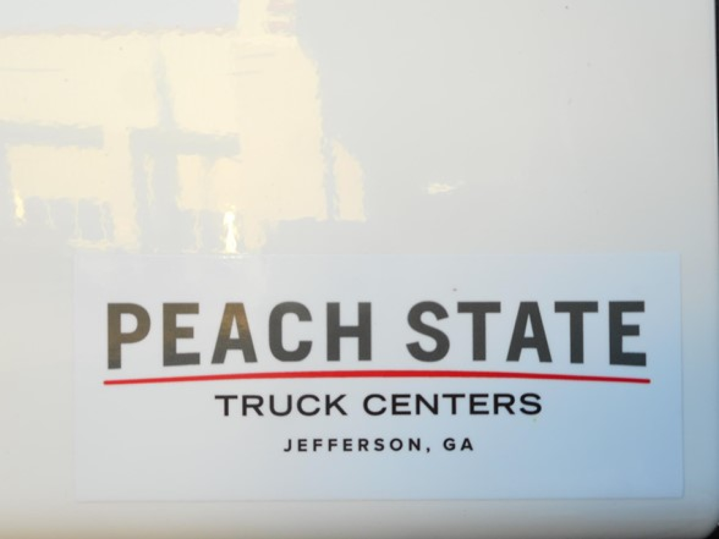 Peach State Truck Centers sticker with text 'PEACH STATE TRUCK CENTERS JEFFERSON, GA' visible.