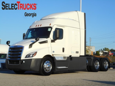 Truck cab showing Freightliner Cascadia 116 with SelectTrucks Georgia logo, white aerodynamic sleeper tractor on lot, VIN 3AKJHPDV2NSMY0489 visible in listing.