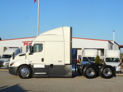 Freightliner Cascadia 116 tractor cab side view showing sleeper cab and dual rear wheels.
