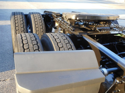 Freightliner Cascadia truck chassis with dual rear axles and exposed underframe; view of tires and frame components.