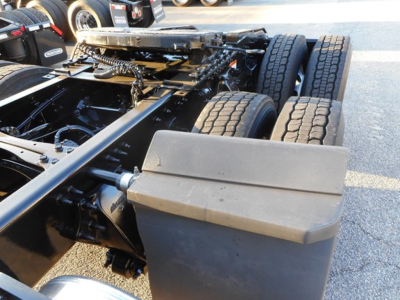 Truck chassis showing rear dual axles and a large rectangular plastic toolbox mounted near the frame; visible tires and frame components.