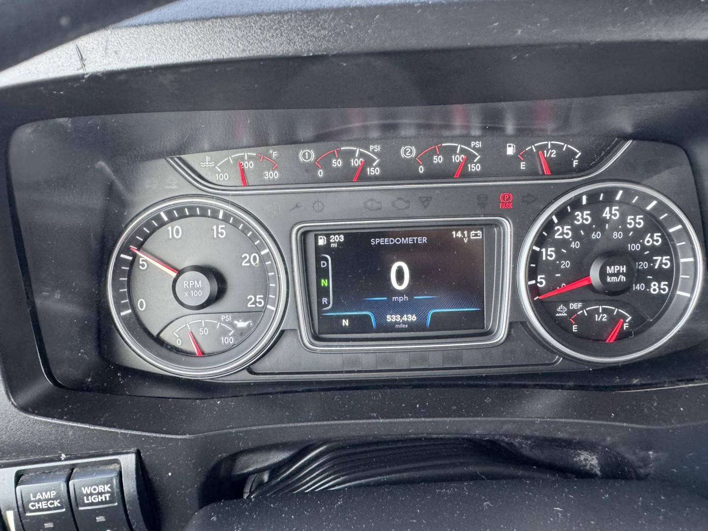 Dashboard of a 2020 International LT showing speedometer, tachometer, and digital display. Center display reads SPEEDOMETER 0 mph and 533,438 miles, with N (neutral) indicator. Left gauge shows RPM, right gauge shows mph.