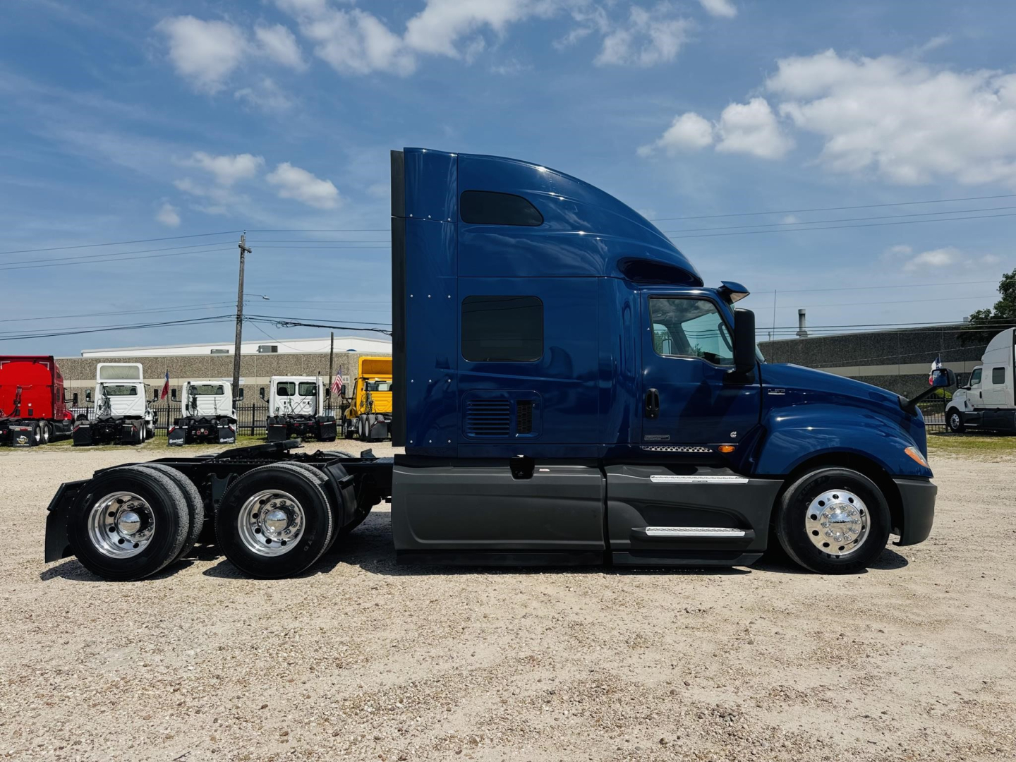Blue 2020 International LT truck tractor side view showing sleeper cab, 2-axle rear with dual wheels, chrome rims, black and gray lower body panels.