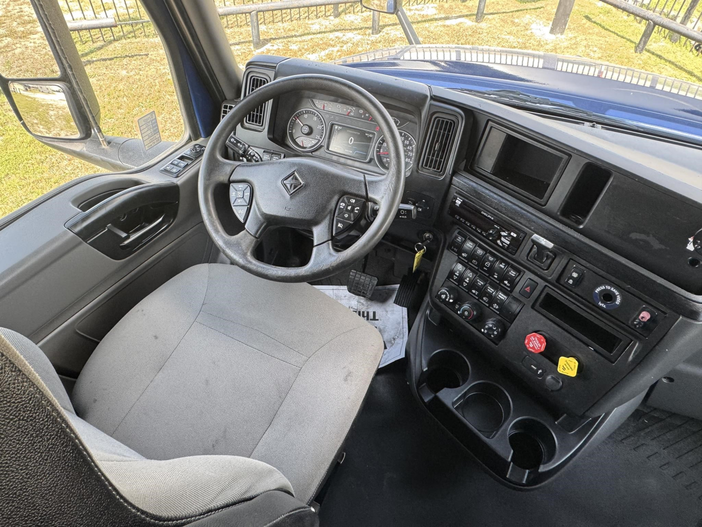 Truck cab interior showing steering wheel, instrument cluster, and center console of a 2020 International LT truck.