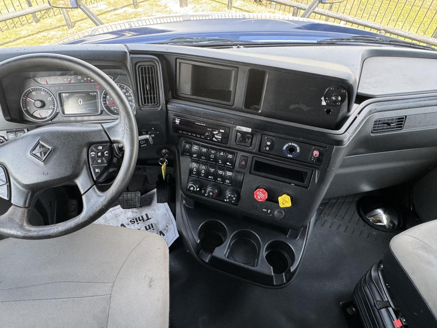 Dashboard and steering wheel of a 2020 International LT cab interior with center console, gauges, and control panel.