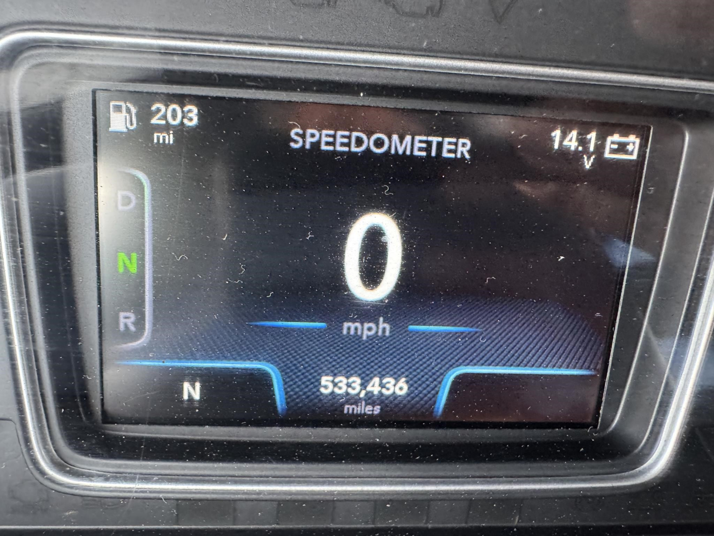 Dashboard speedometer showing 0 mph, N gear indicator, 203 mi fuel/odometer, 533,436 miles total, and 14.1 V on a digital display.