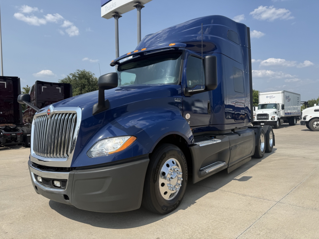 Blue 2020 International LT semi-truck sleeper cab front-left view with chrome grille and dual rear axles.