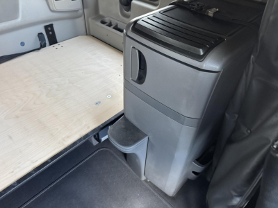 Interior cabin area of a used 2020 International LT showing a plywood floor and center console with storage components.