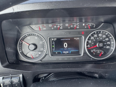 Dashboard of a 2020 International LT showing speedometer, tachometer, and digital display. Center display reads SPEEDOMETER 0 mph and 533,438 miles, with N (neutral) indicator. Left gauge shows RPM, right gauge shows mph.