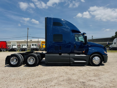Blue 2020 International LT truck tractor side view showing sleeper cab, 2-axle rear with dual wheels, chrome rims, black and gray lower body panels.
