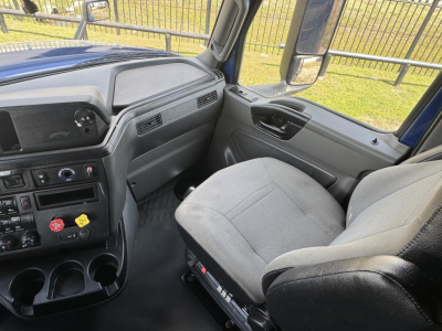 Truck cabin interior showing driver seat and dashboard of a 2020 International LT sleeper truck, with steering wheel, control panel, and window views.