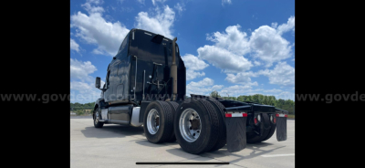 Rear view of a 2009 Peterbilt 387 tractor with dual rear axles and wheels visible, showing the back of the cab and chassis.