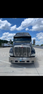 Peterbilt 387 front view showing large chrome grille, bumper, headlights, and license area.
