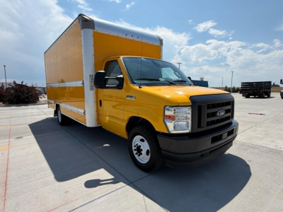Ford E-Series box truck with a yellow cab and large cargo box, front three-quarter view, VIN sticker not visible.