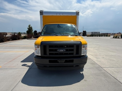 Ford E350 cutaway truck front view with yellow cab and black grille, large cargo box behind. No visible text on image. 